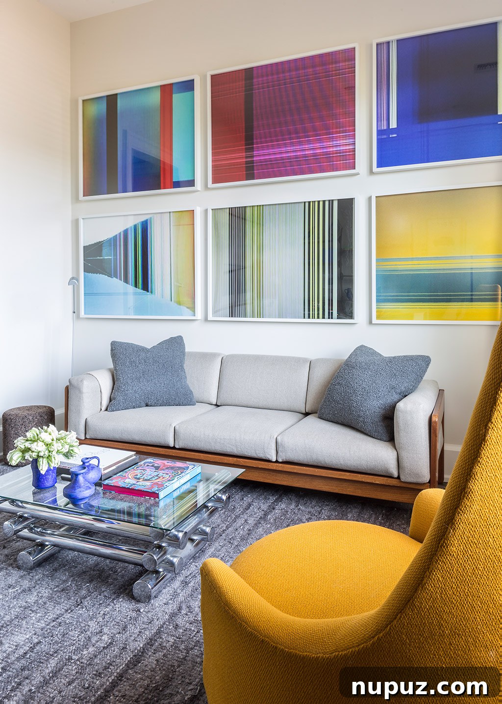 Timothy Brown Studio: Elevated Aesthetics 4 Vibrant lounge area with a blue sofa, colorful cushions, and a striking piece of contemporary art