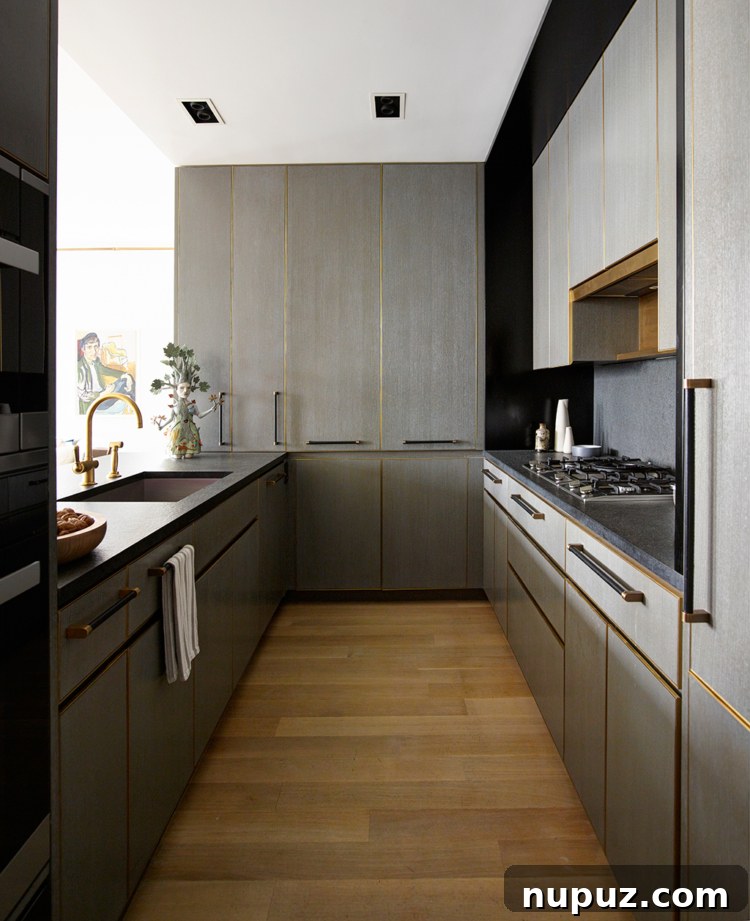 Timothy Brown Studio: Elevated Aesthetics 6 Sleek, modern kitchen with grey cabinetry, gold hardware, and a large island with bar stools