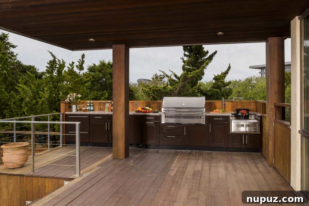 Contemporary outdoor kitchen featuring built-in cabinetry and professional grill
