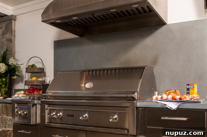 Expansive outdoor kitchen with various cooking stations, including a pizza oven