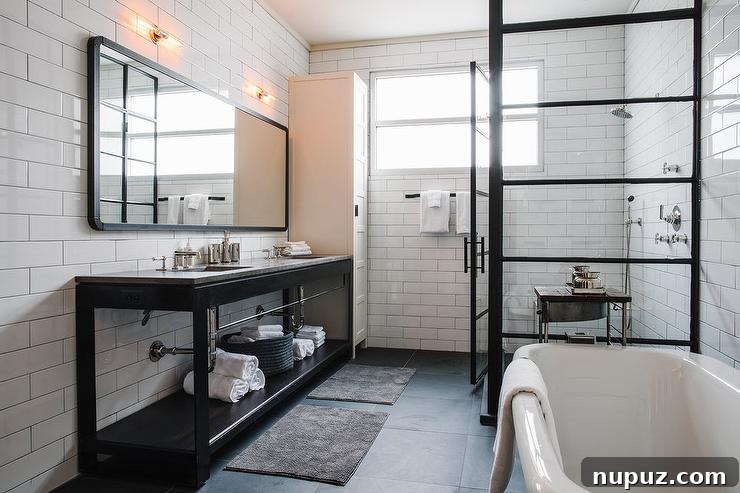 A modern bathroom featuring a walk-in shower with striking black steel frame doors, adding an industrial chic touch.