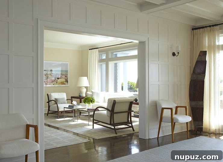 Sophisticated dining space by Brian Brady Design, featuring a grand dining table, elegant chairs, and artistic lighting.