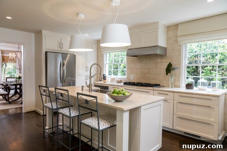 Step Inside Greensboro's Charming Oasis 7 Cozy seating area with a fireplace, comfortable armchairs, and thoughtful decorative touches, creating an inviting atmosphere.