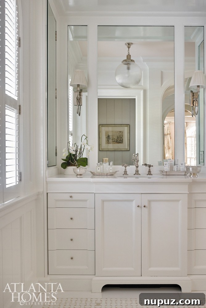 Clean and elegant bathroom vanity with a large mirror and ample lighting