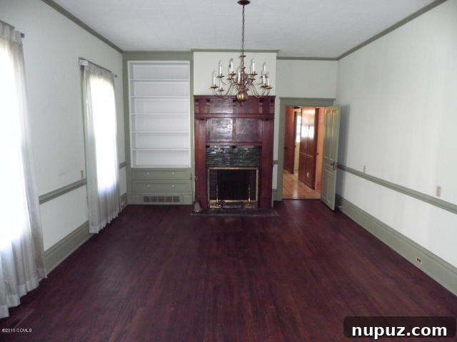 Old, stained carpet covering original hardwood floors in a historic home