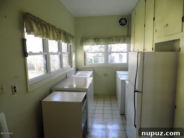 Old, cluttered laundry room in a beach house needing renovation