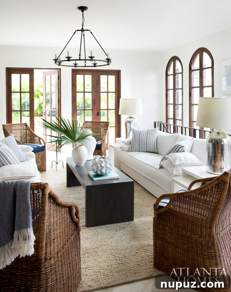 Costa Rica Dream Home Unveiled 2 Luxurious Costa Rican beach house living room with natural wicker furniture and ocean views, designed by Beth Webb, featured in Atlanta Homes & Lifestyles.