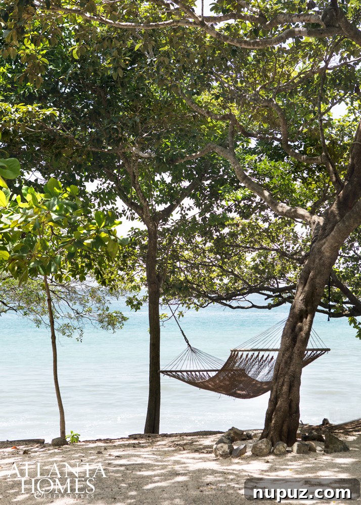 Costa Rica Dream Home Unveiled 14 Hammock by the beach at a Costa Rican resort, offering a perfect spot for ultimate relaxation.