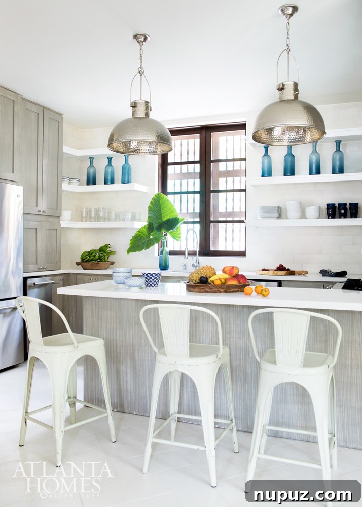 Costa Rica Dream Home Unveiled 4 Bright and airy vacation kitchen in a Costa Rican beach house, featuring limewashed cabinets and an abundance of fresh tropical fruit.