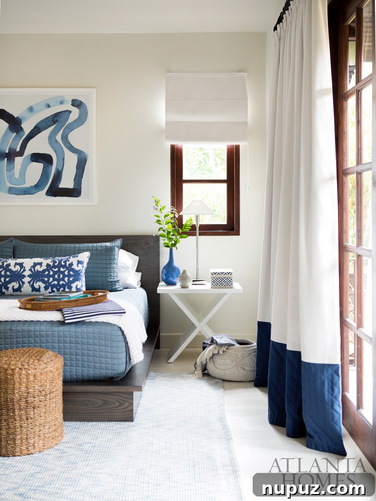 Costa Rica Dream Home Unveiled 7 Blue and white bedroom in a Costa Rica beach house, featuring abstract art and simple, uncluttered coastal decor.
