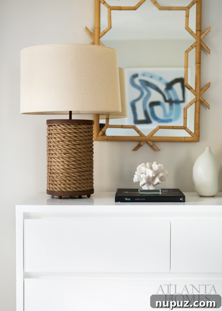 Costa Rica Dream Home Unveiled 8 Coastal themed bedroom with natural textures like bamboo, rope, and coral, featuring blue and white decor in a Costa Rican beach house.