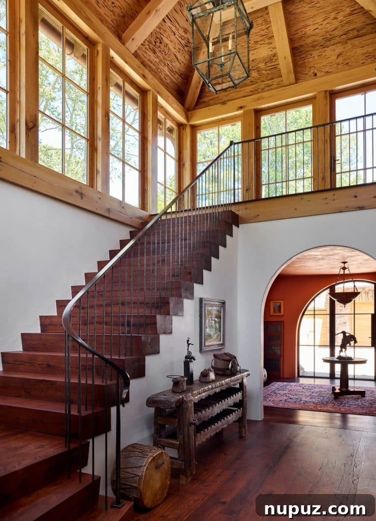 Grand foyer and staircase featuring elegant millwork and classic furnishings in a Roswell, Georgia luxury home.
