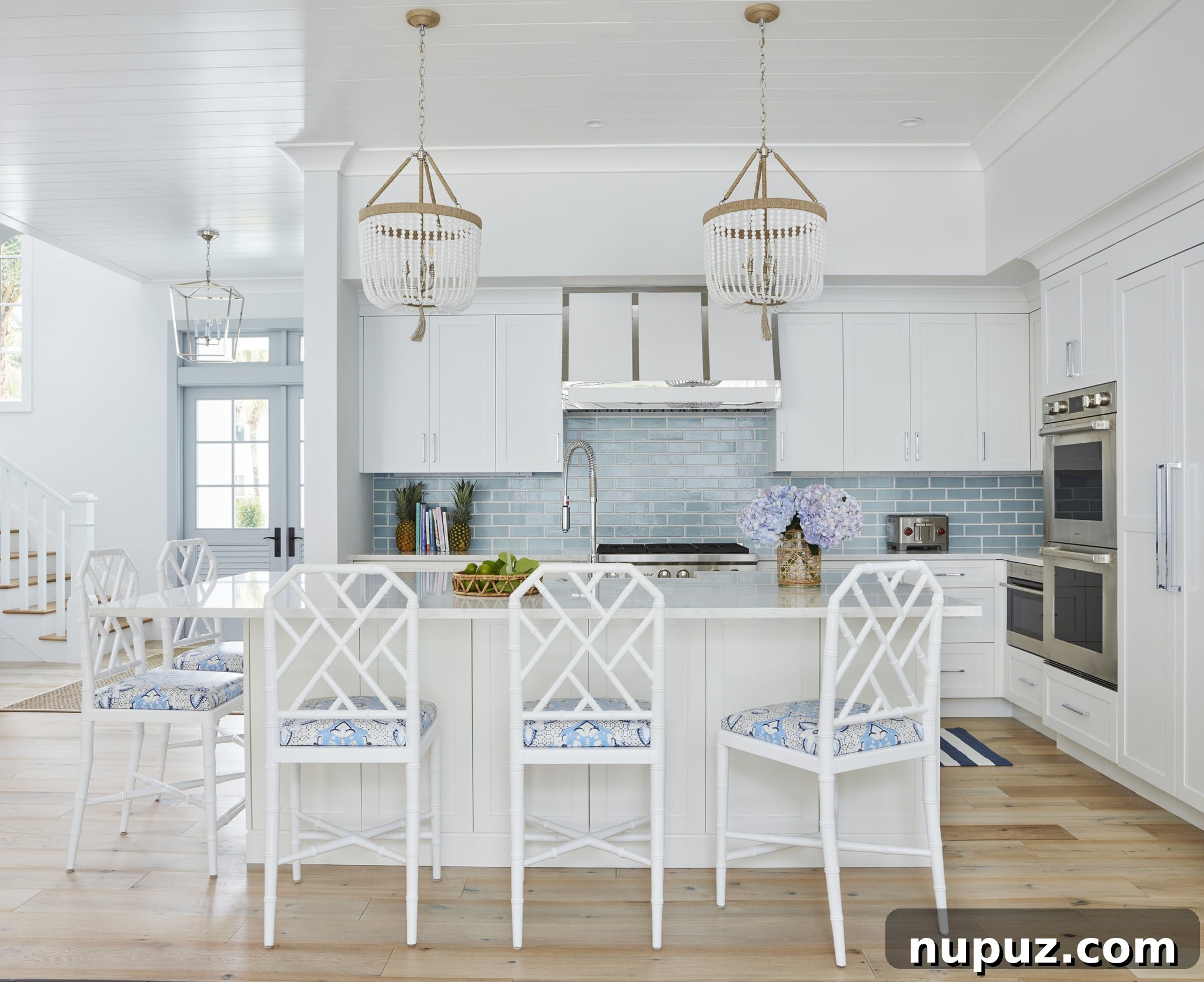 Kara Miller Crafting Kitchens of Unrivaled Beauty 3 An elegant Kara Miller kitchen showcasing dark stained wood cabinetry, white countertops, and a striking range hood. The design blends traditional elements with modern comfort, creating a sophisticated yet inviting space, as documented by Brantley Photography.