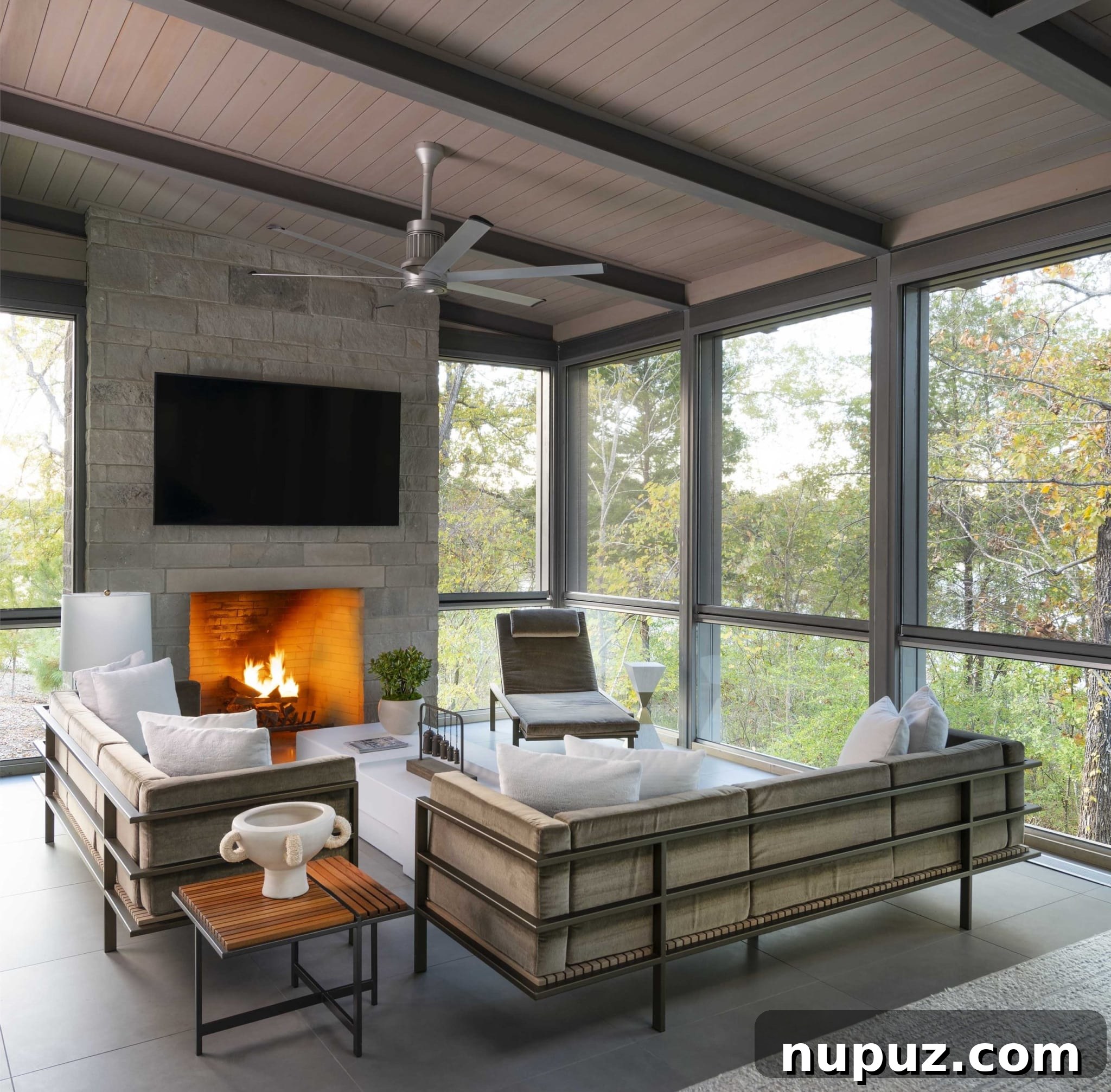 East Texas Glass House: A Modern Architectural Marvel 5 Close-up interior shot of the living room showcasing the floor-to-ceiling glass windows and the stunning panoramic view of the lake and forest from within the house.
