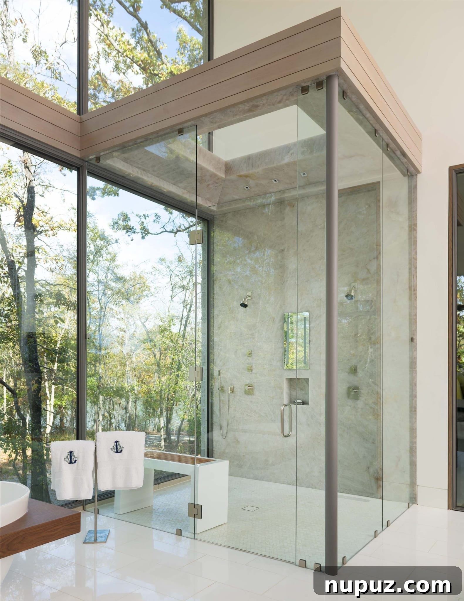 East Texas Glass House: A Modern Architectural Marvel 10 Exterior shot of the glass house at dusk or dawn, with interior lights softly illuminating, showcasing its integration with the forest and the reflective quality of the glass.