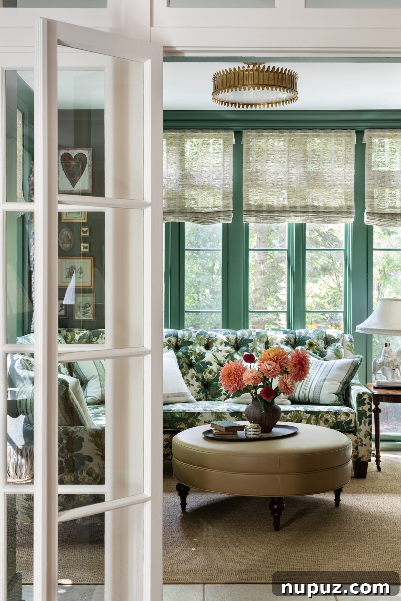 Alexandra Kaehler's elegant foyer design, featuring a carefully selected stripe wallpaper pattern that enhances the home's unique ambiance and makes a powerful first impression.