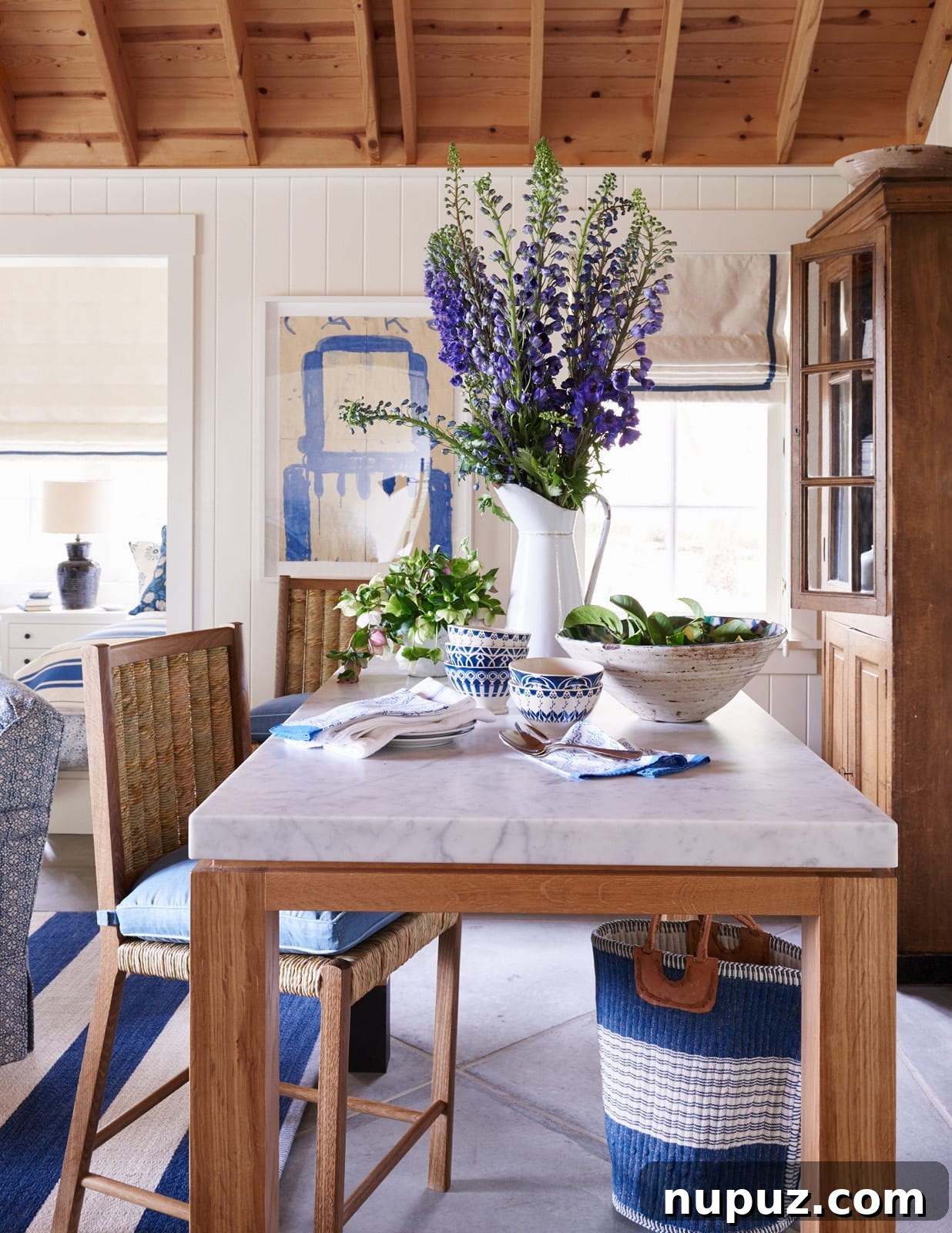 A stunning blue and white kitchen by Mark D. Sikes, featuring elegant white cabinetry, blue accents, and classic design elements for a timeless appeal.