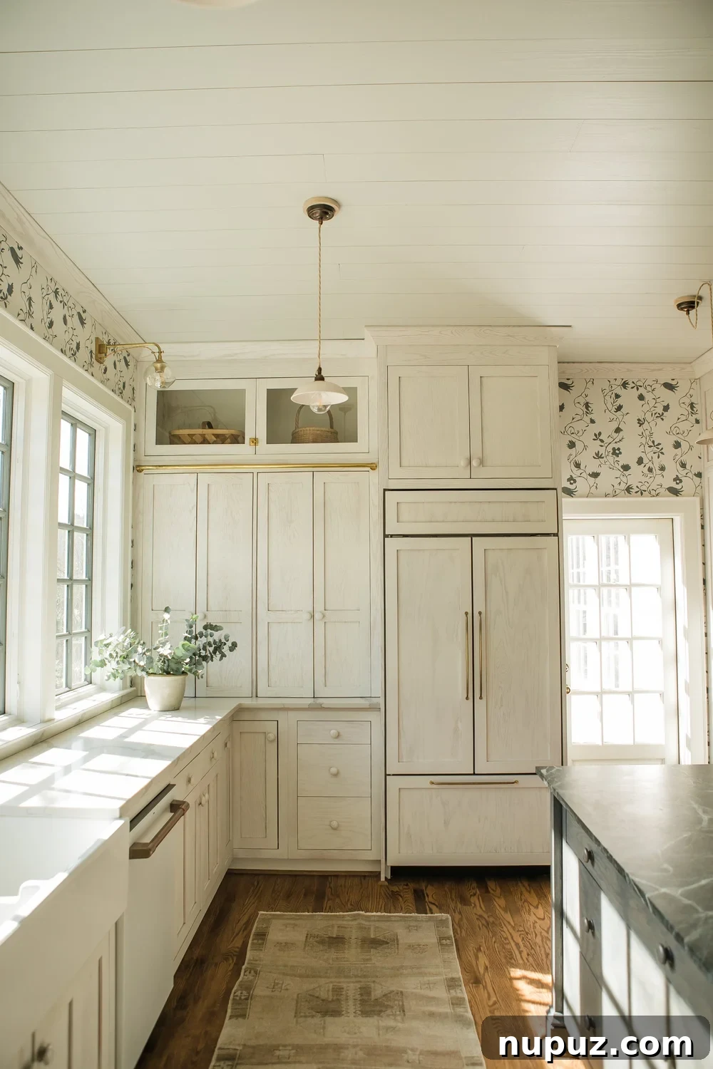 Infuse Your Kitchen with Personality Smart Design Solutions 2 Monica Stewart designed Misfit House kitchen featuring warm wooden cabinets, brass library lights, and a charming desk nook. Kristin Karch Photography.