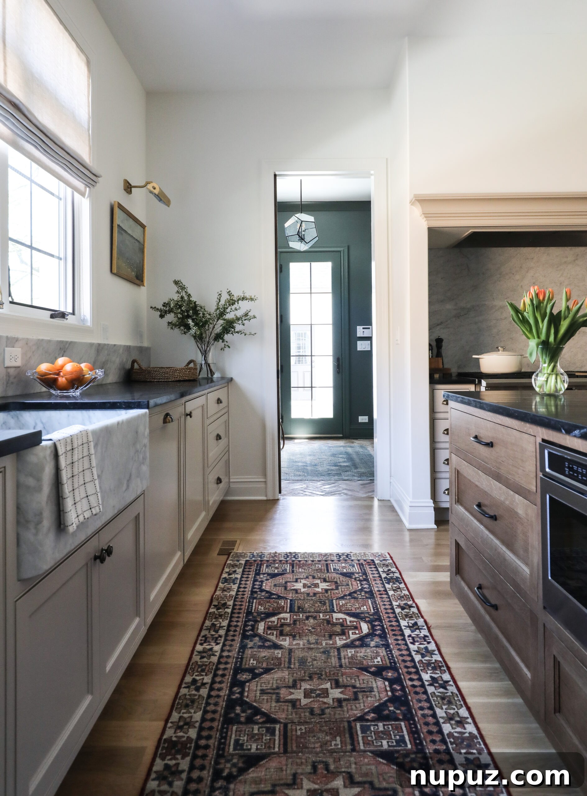 Bright kitchen featuring light sage green lower cabinets, open shelving, and abundant natural light, creating a fresh and inviting atmosphere by Park and Oak Design.