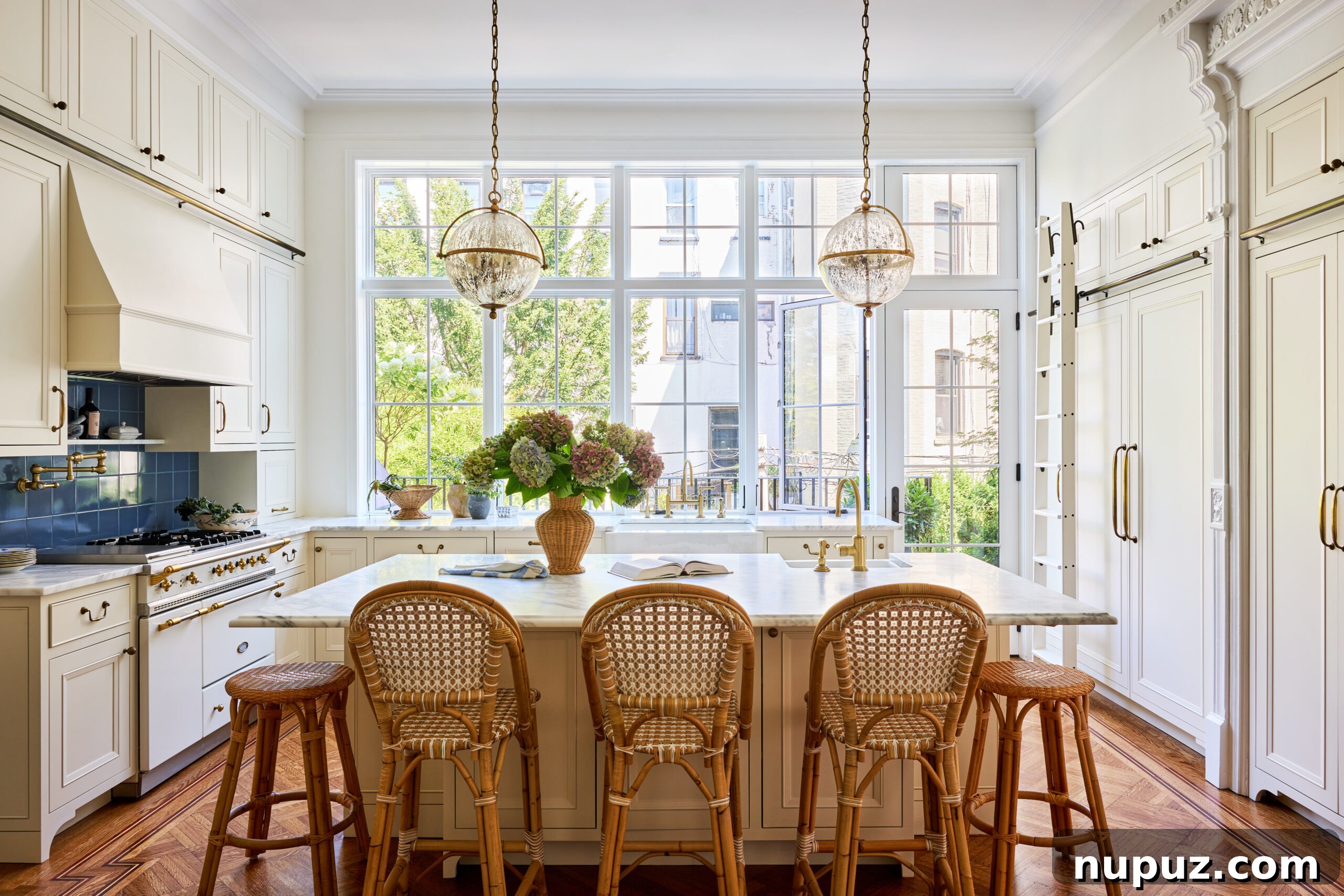 Modern kitchen by Jennifer Hunter featuring stylish rattan stools and elegant pendant lights over the island, photographed by Kristen Francis.