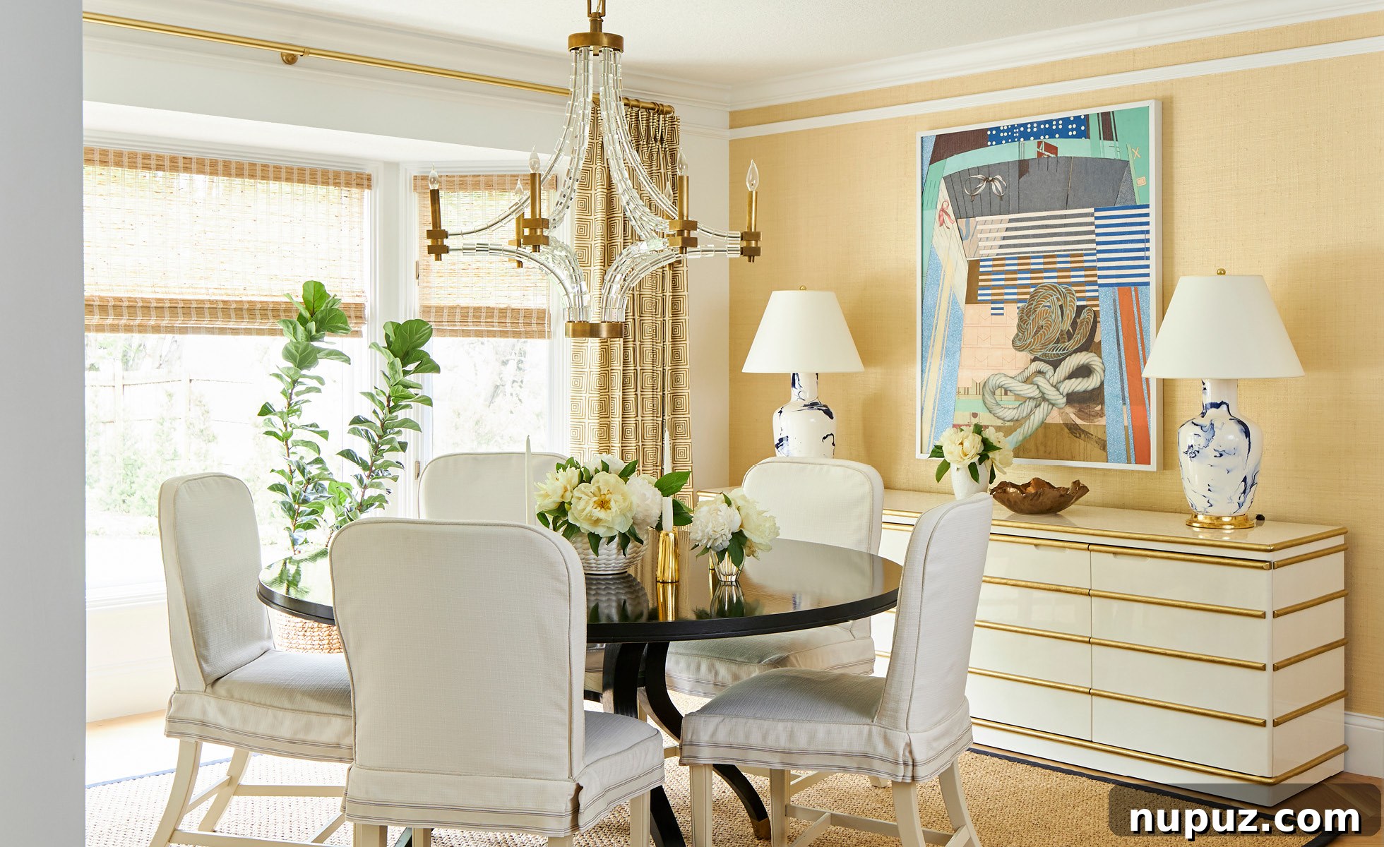 Elegant dining room featuring warm grasscloth walls, a classic dining table, and sophisticated chairs in an Amanda Reynal designed home.