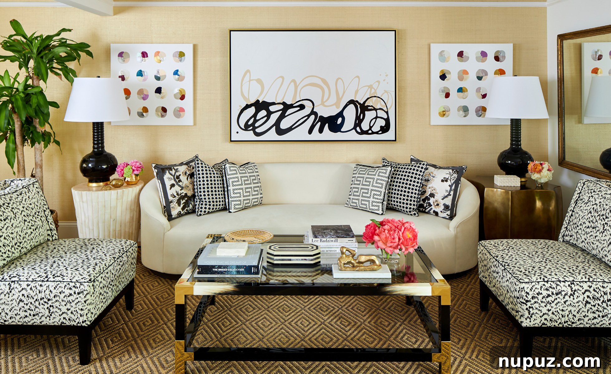 Elegant hallway with neutral interiors, textured wall coverings, and sophisticated lighting, accented by a Schumacher acanthus leaf wallpaper panel, designed by Amanda Reynal.