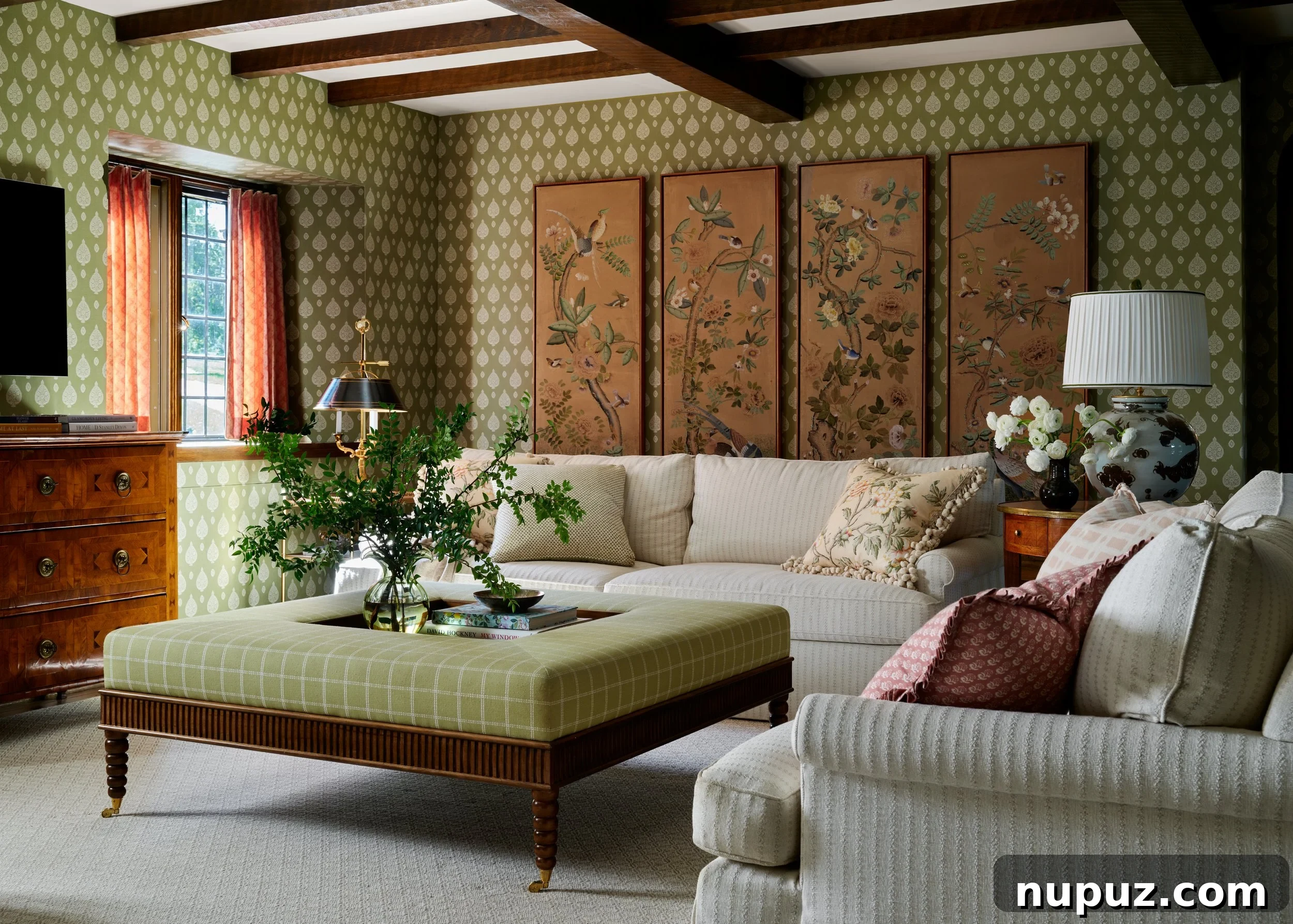 Cozy family room with wood beams and charming wallpapered walls by Jenkins Interiors, creating a welcoming atmosphere.