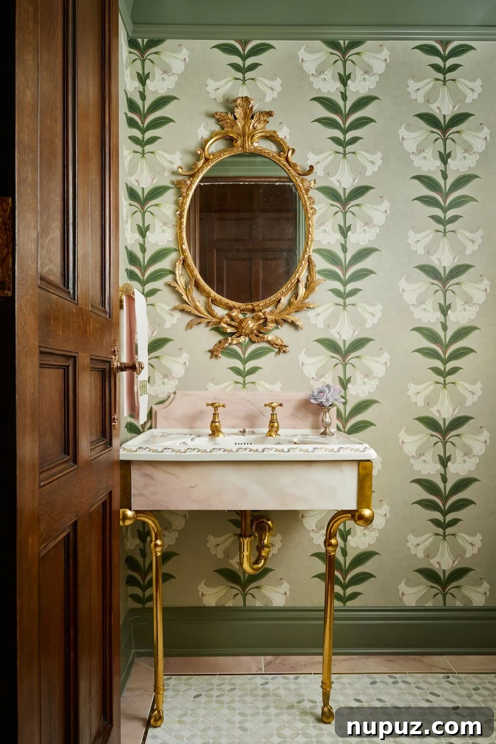 Charming powder room with elegant wallpaper and a console marble sink, a Jenkins Interiors design.