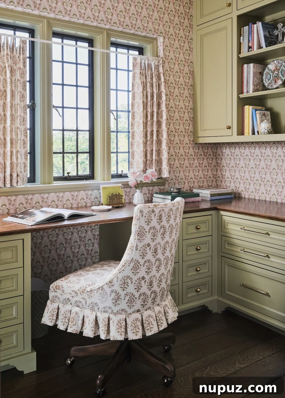 Charming home office with patterned wallpaper and elegant green cabinets, designed by Jenkins Interiors for productivity and style.
