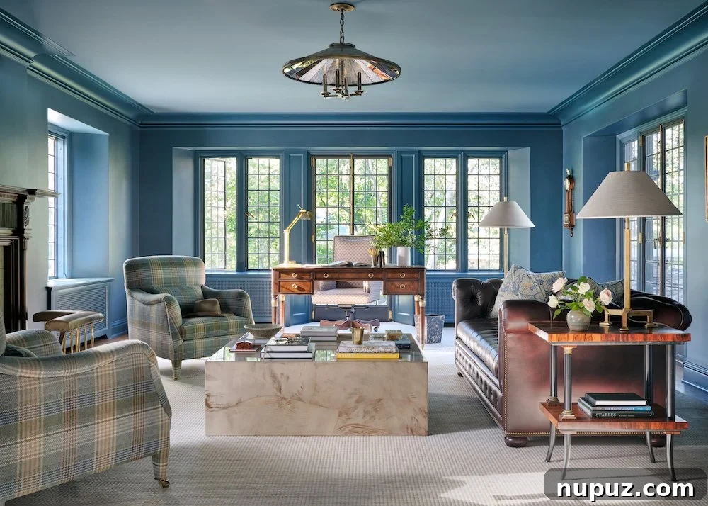 Moody blue, color-drenched room, exuding sophisticated tranquility by Jenkins Interiors.