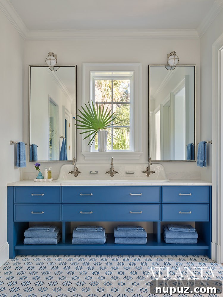 Another elegantly appointed blue and white bathroom in the Sea Island residence, showcasing the serene and consistent coastal aesthetic throughout the home.