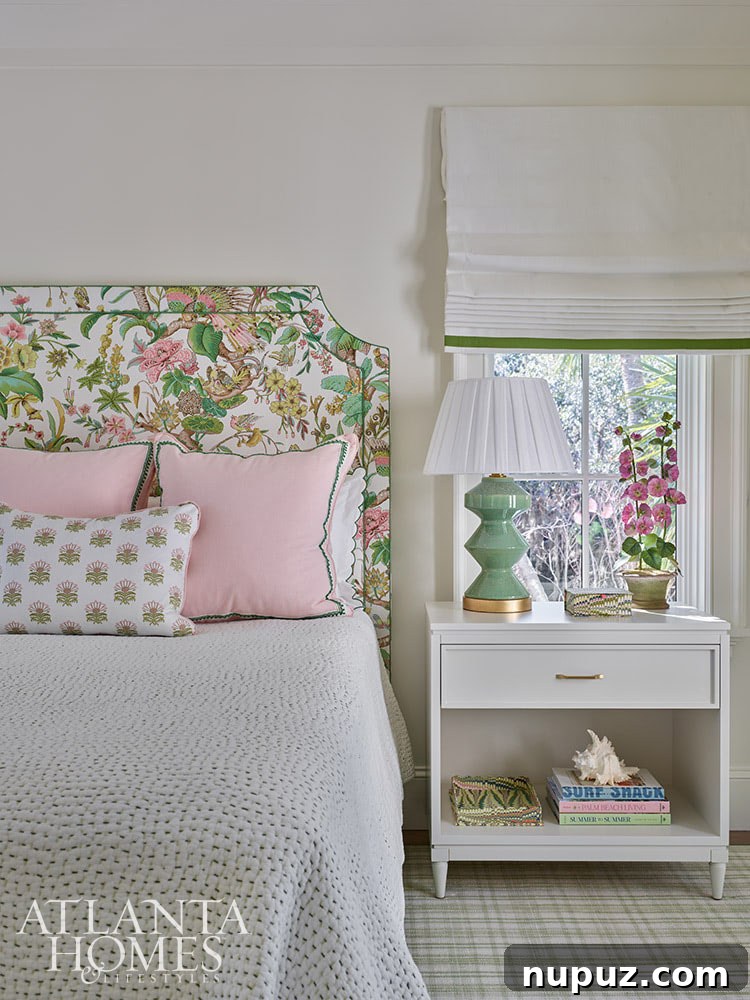 A charming guestroom in the Sea Island home, featuring a delightful pink and green headboard, offering a vibrant and unique twist on the coastal theme.