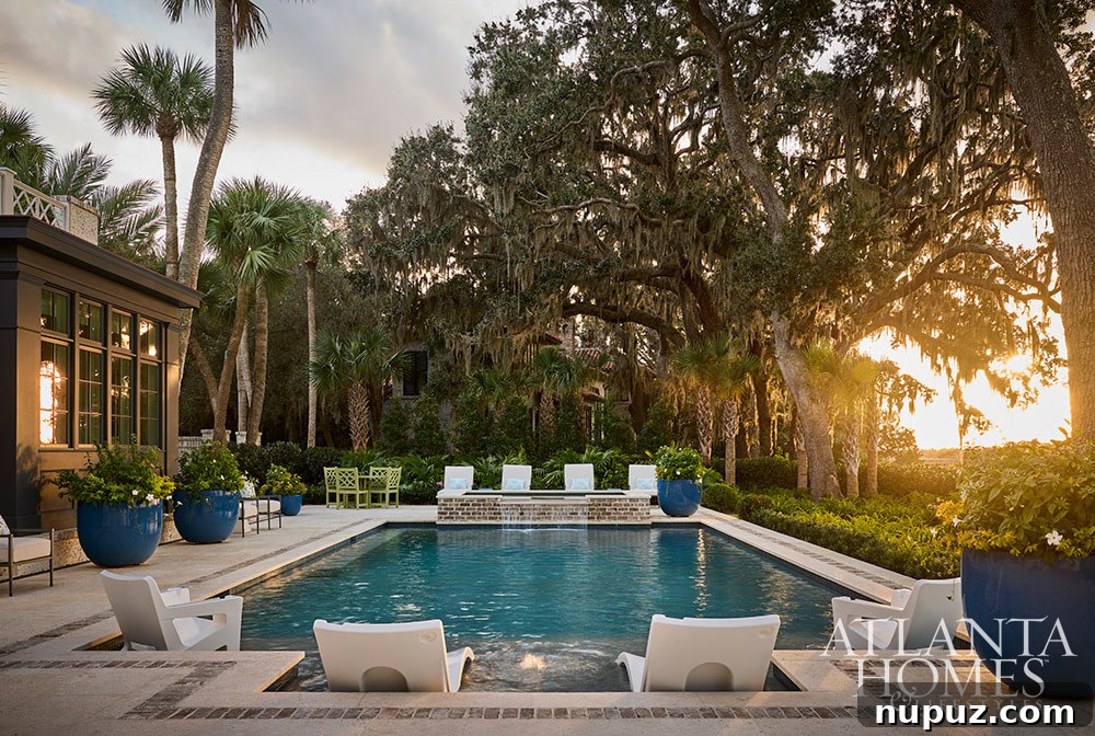 The luxurious pool area of the Sea Island coastal oasis, designed for ultimate relaxation and sophisticated outdoor entertaining.