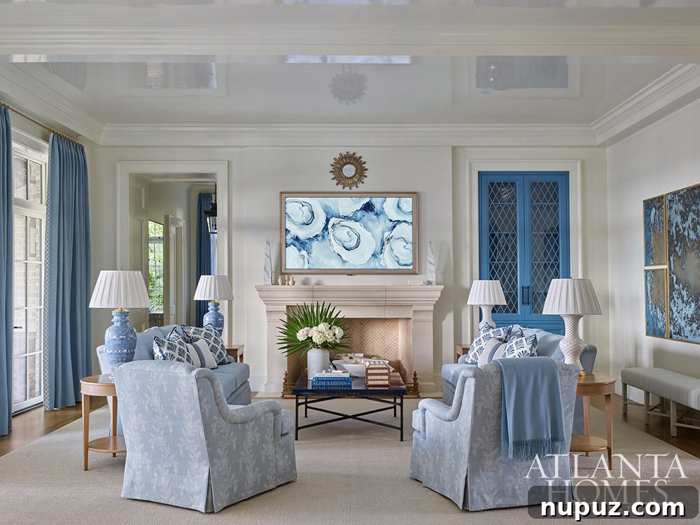 A comfortable family room in the Sea Island residence featuring a cleverly framed hanging TV, seamlessly integrating modern entertainment with stylish coastal design.