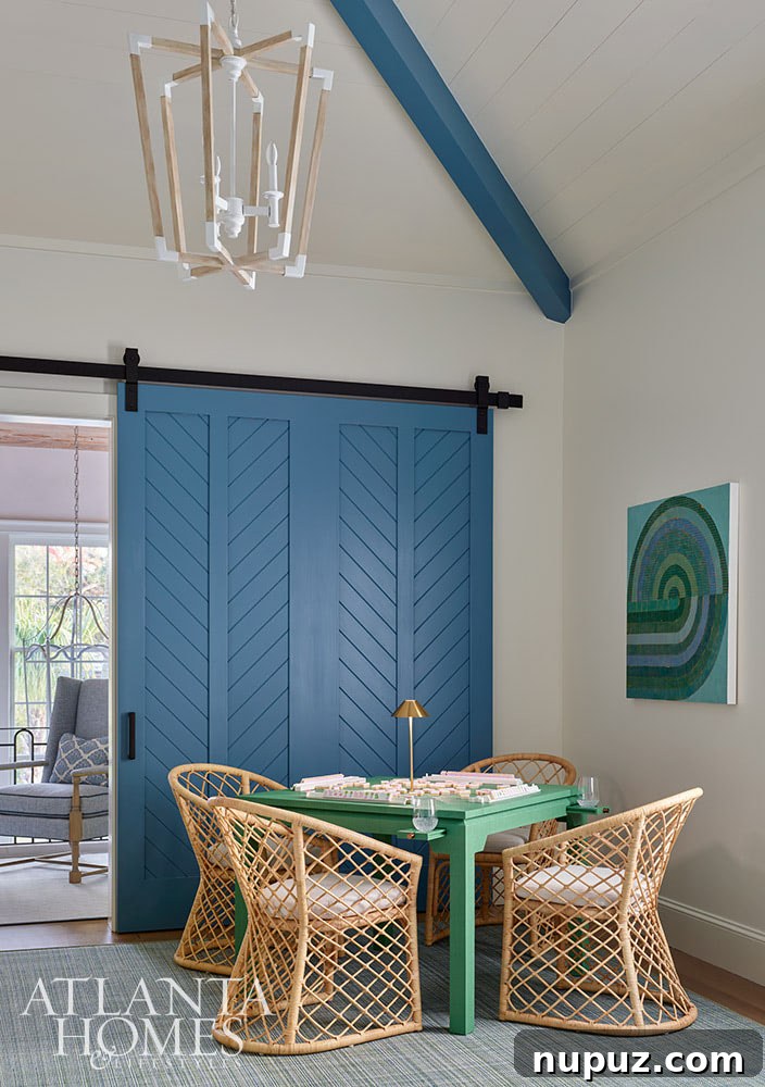 A vibrant game room in the Sea Island home featuring a striking green lacquered game table, adding a playful yet sophisticated touch to the interior design.