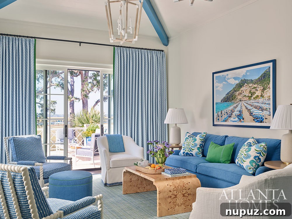 A cozy blue and white family room in the Sea Island home, beautifully accented with stylish bobbin chairs, creating a refined and inviting coastal ambiance.