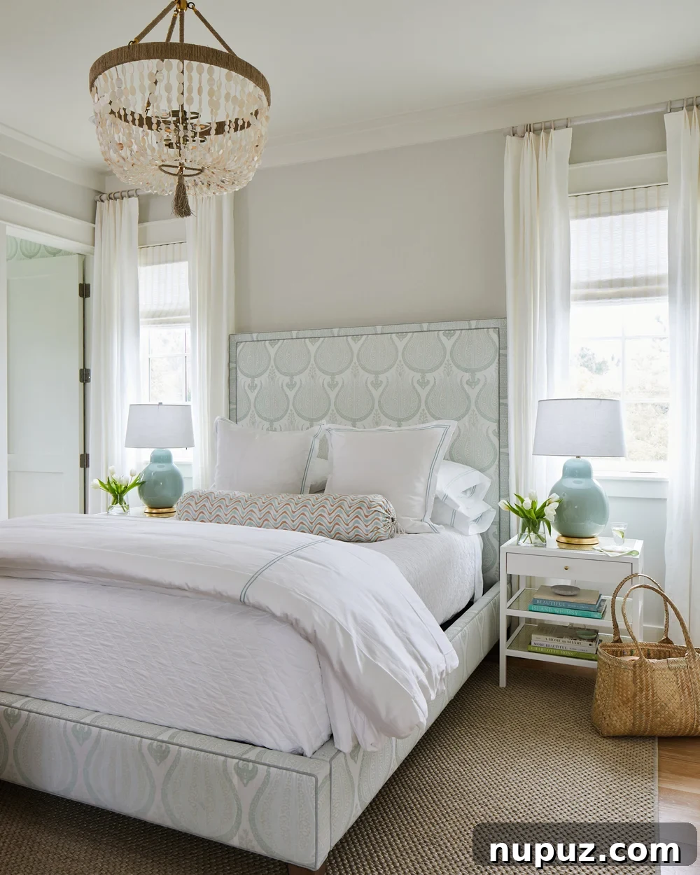 Breezy Blue and White Coastal Bliss 10 A serene blue and white beach house bedroom, beautifully designed by Kara Miller, showcasing a harmonious blend of comfort and coastal elegance.