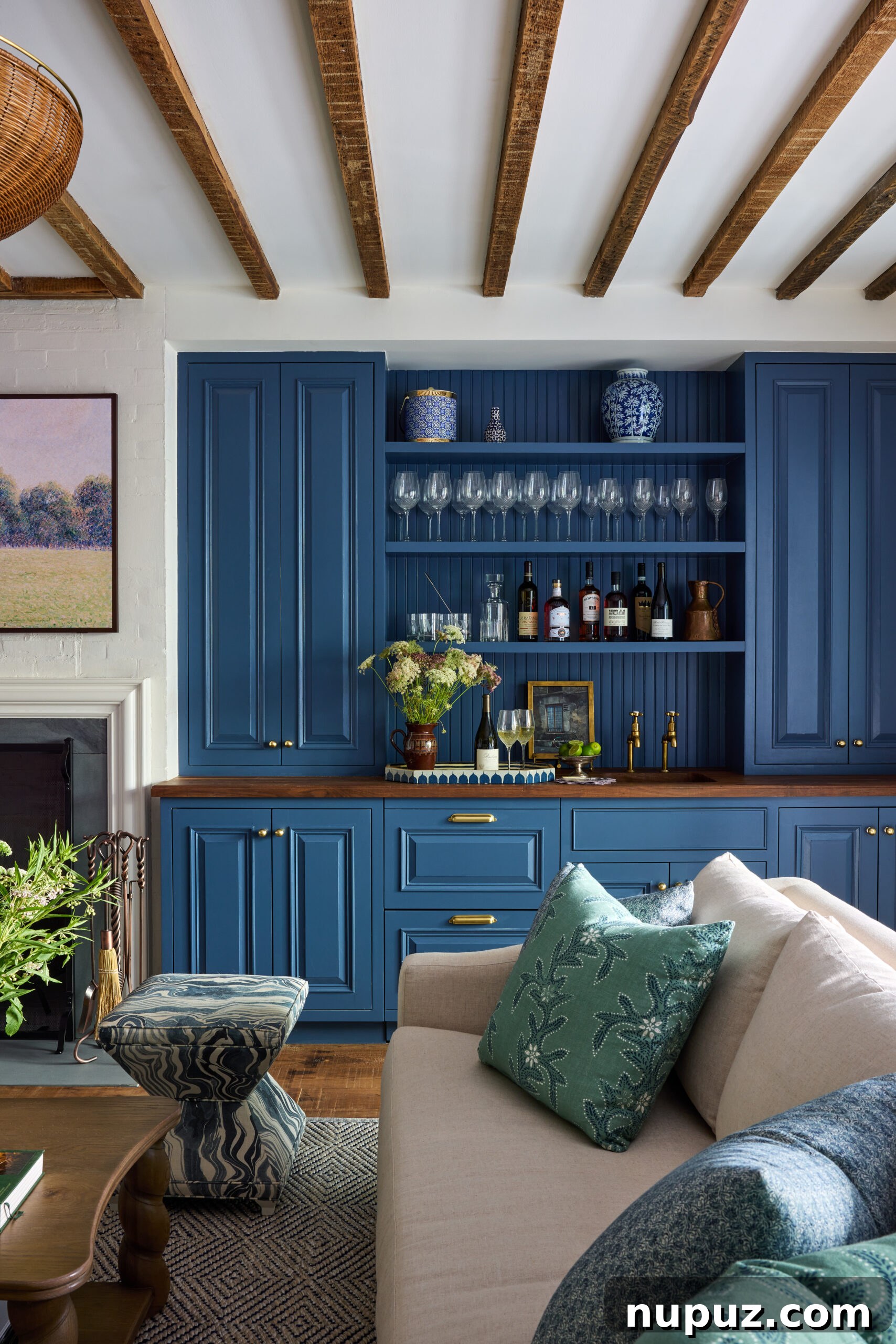 Living room's custom bar area with wood beams and a Visual Comfort chandelier