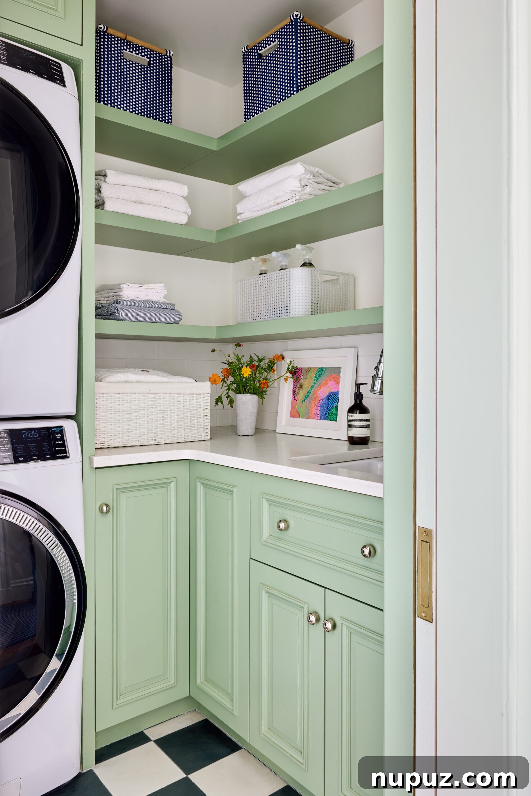 Charming laundry room with green cabinets and white quartz countertops