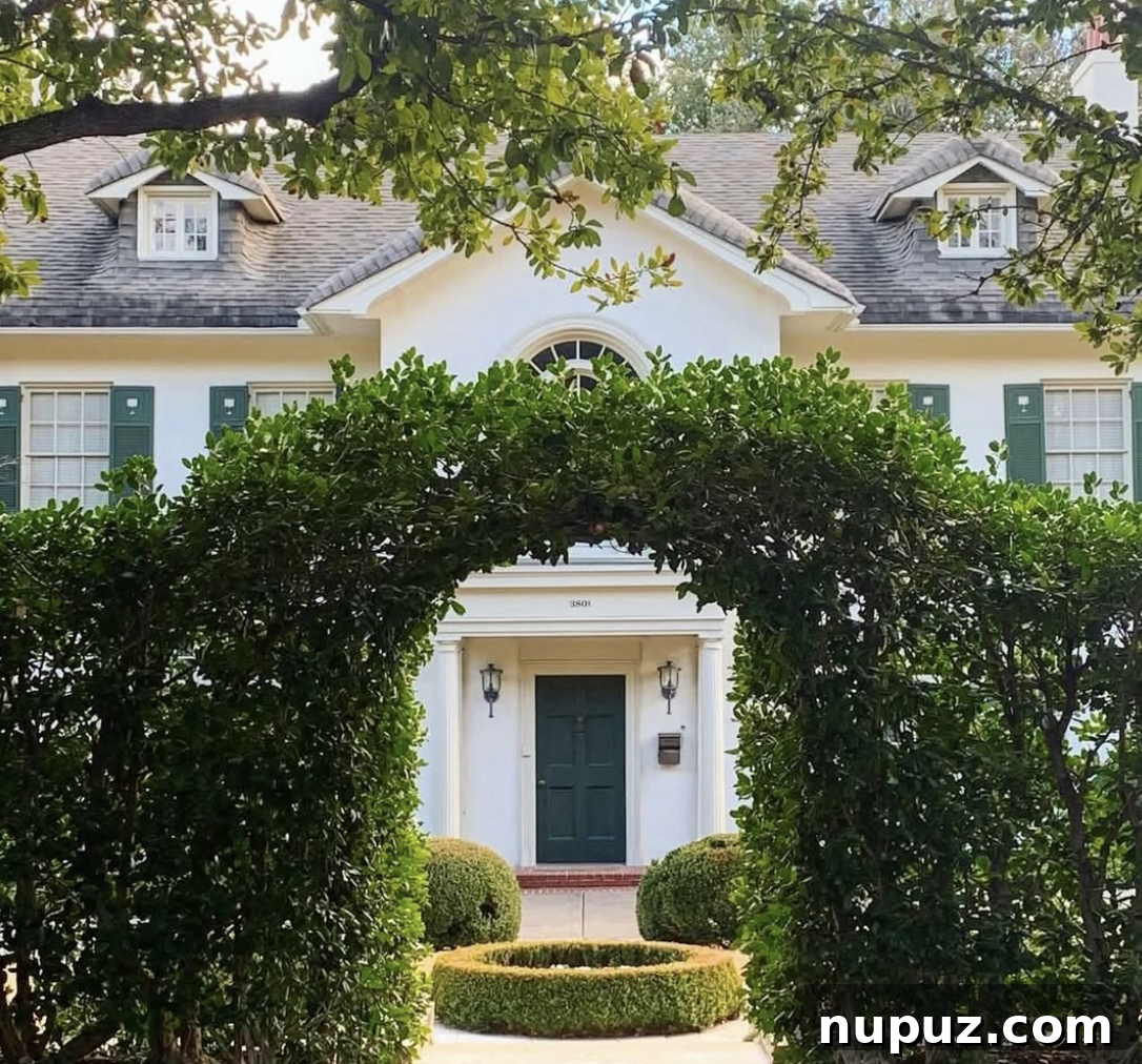 7 Homes Where Boxwoods Command the Landscape 7 Historic home showcasing expansive boxwood parterres and a meticulously maintained landscape, reflecting a heritage of refined gardening.