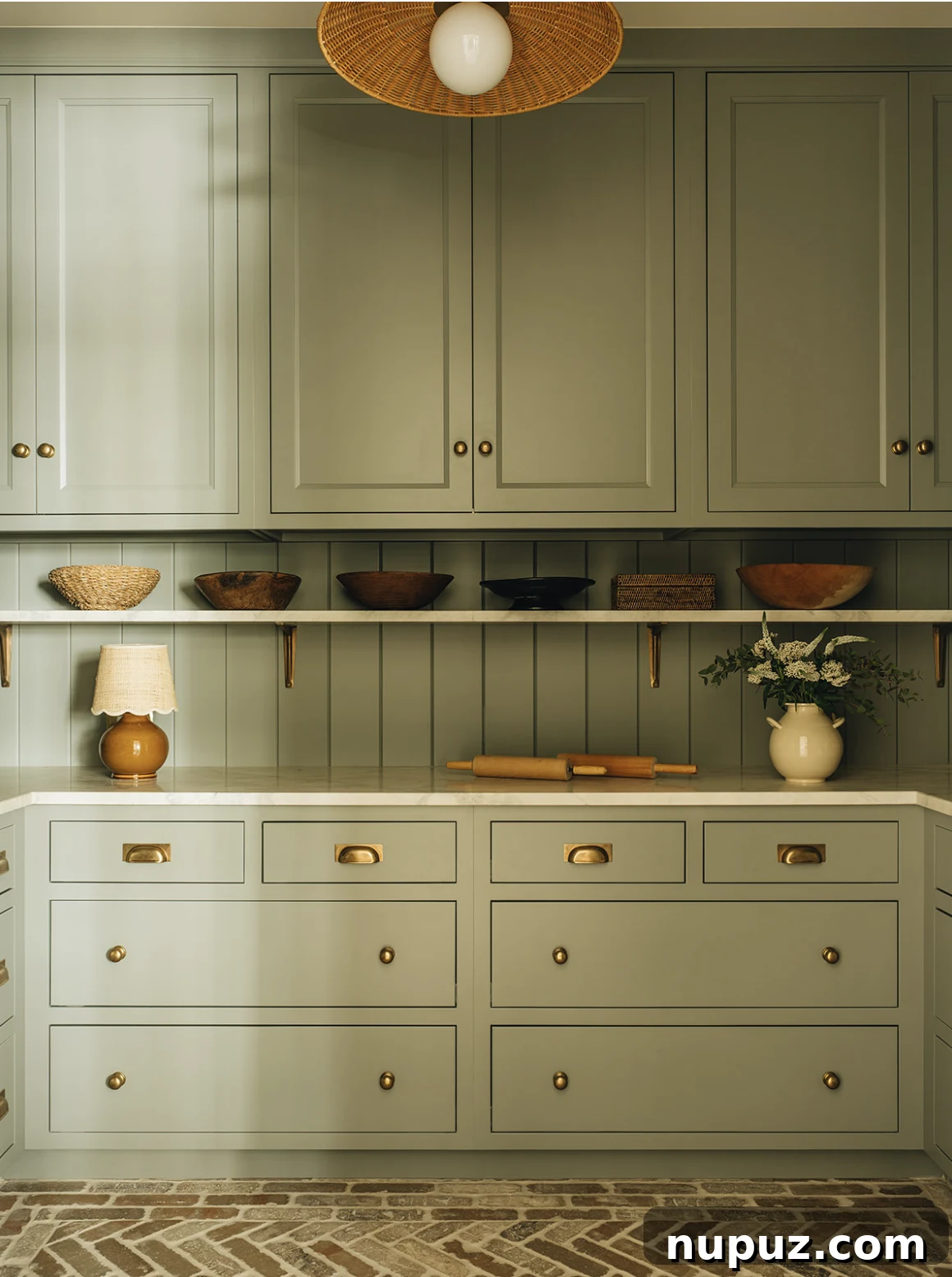Sage green butler's pantry by Jean Stoffer Design, offering elegant storage solutions
