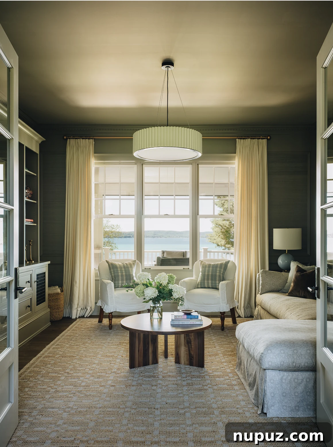 Jean Stoffer Design living room featuring a comfortable sectional sofa and expansive lake views