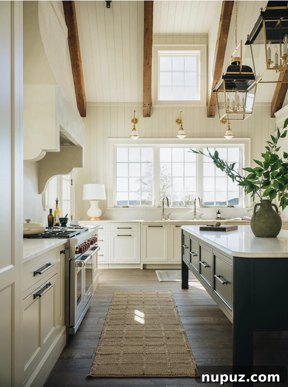 Jean Stoffer Design kitchen featuring white clapboard, elegant black and gold lanterns, and unique bar stools