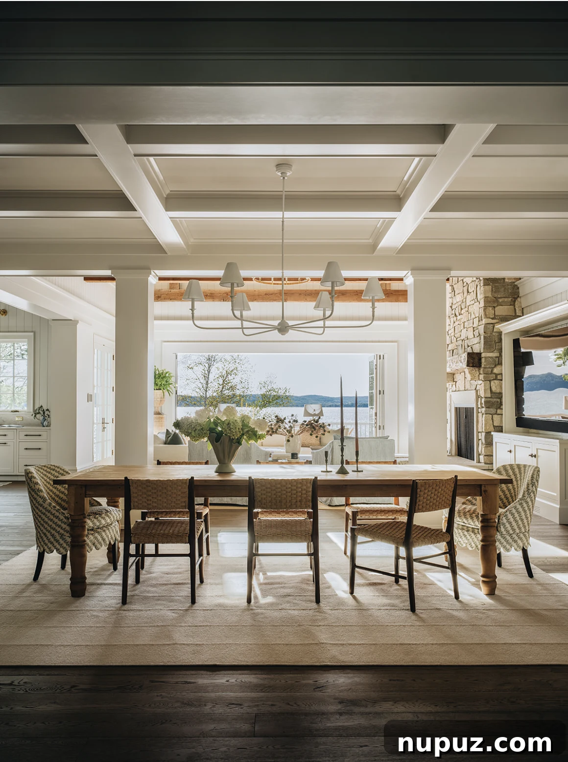 Jean Stoffer Design dining room with water view, showcasing elegant lighting and a refined aesthetic