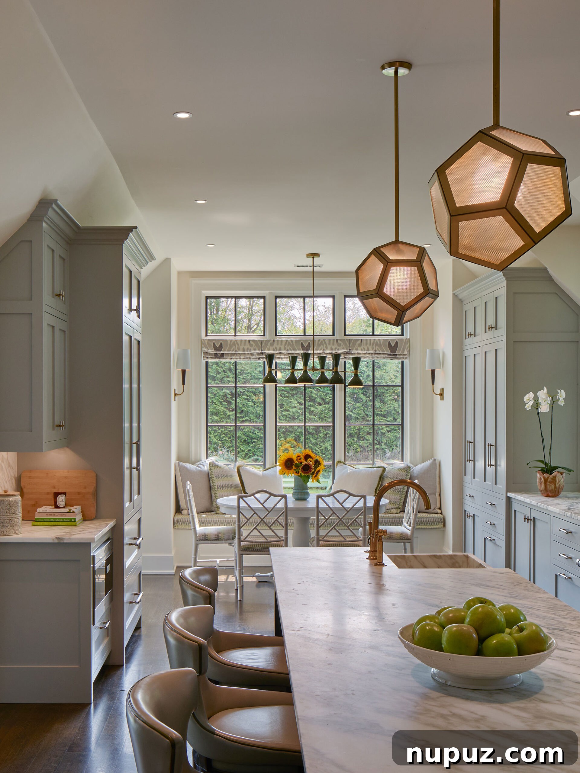 Kitchen with gray cabinets and dining area with banquette seating and round table