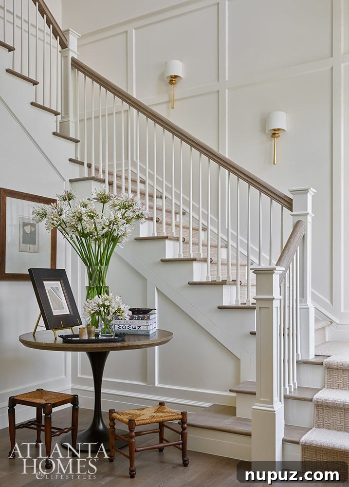 Beautiful entryway with paneled walls and round entry table