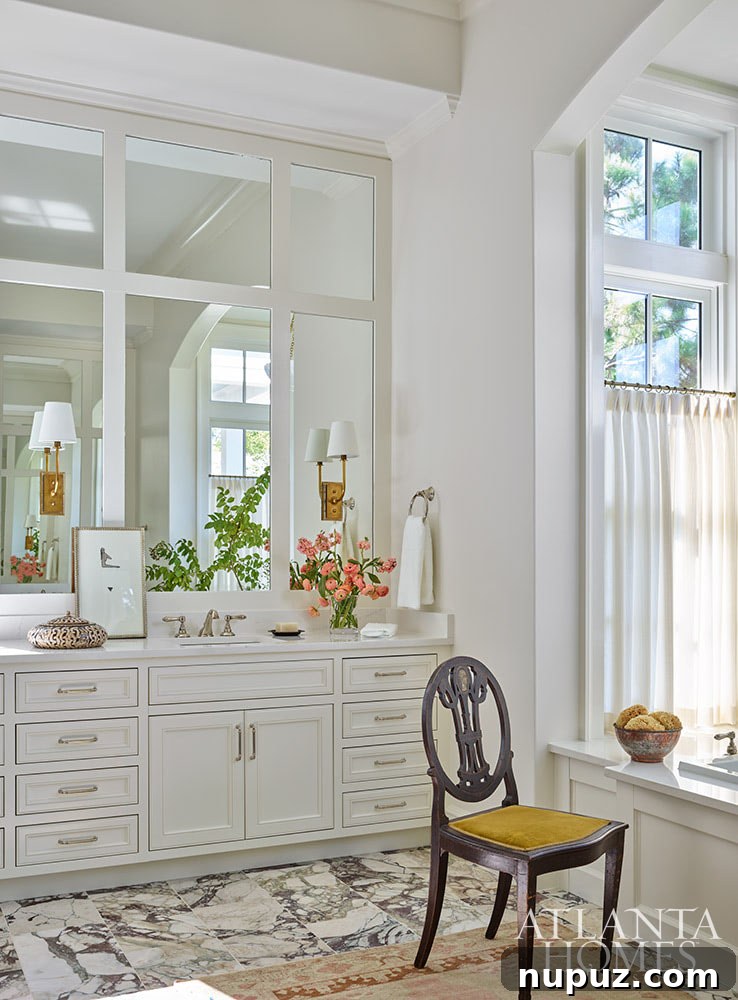 Bedroom with built-in bathtub and white cabinetry