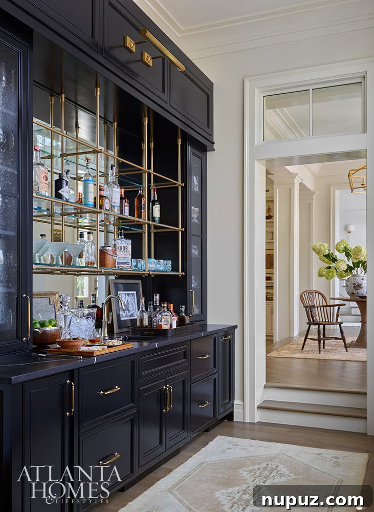 Butler's pantry in dark blue with brass library lights and hanging shelf