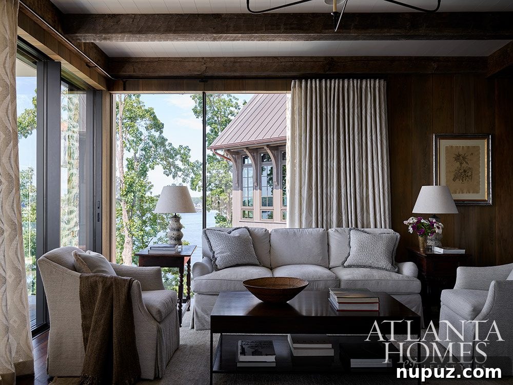 Lake house living room with dark stained wood and floor-to-ceiling windows