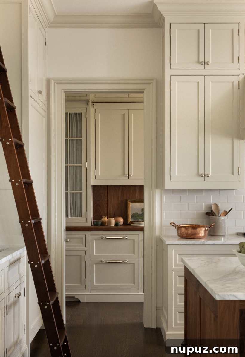Timeless Home Tour: Warm Neutrals and Layered Interior Style 6 Double cabinetry in the kitchen with a library ladder